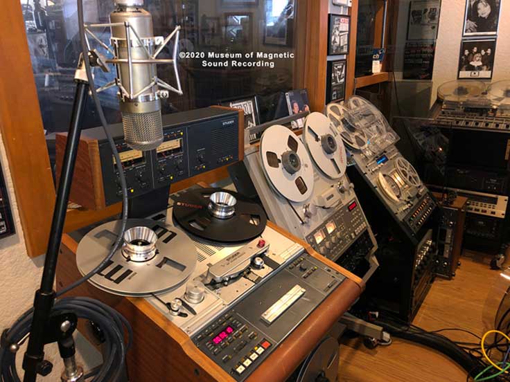 A Neumann U48 microphone (one of a matched pair with sequential serial numbers), and Studer A-807, Tascam BR-20T, Pioneer RT-909, Pioneer RT-707 and TASCAM 80-8 recorders. The latter has a tape with 30 minutes of Willie Nelson recorded live at Austin’s Riverbend Baptist Church, which came with the recorder. Below those are a a TASCAM DX-8 eight-track noise reduction unit; Alesis LX20 ADAT recorder and TASCAM 302 cassette duplication deck. Sitting on its side is a Teac A-4010 recorder.