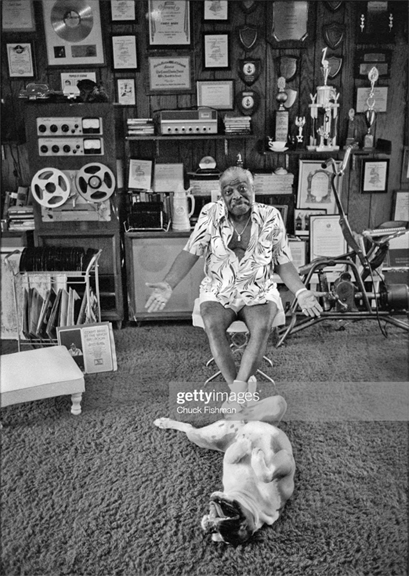 Count Basie (born Willian Basie, 1904 - 1984), and his bulldog Graf, in his home, Freeport, Bahamas, March 1979 - Concertone reel tape recorder in background