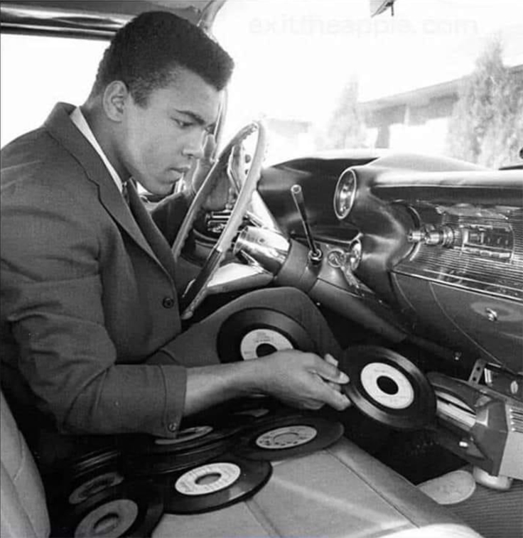Muhammad Ali with 45 rpm record player in his car